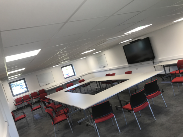 Modern office conference room with LED ceiling lighting and AV fit-out