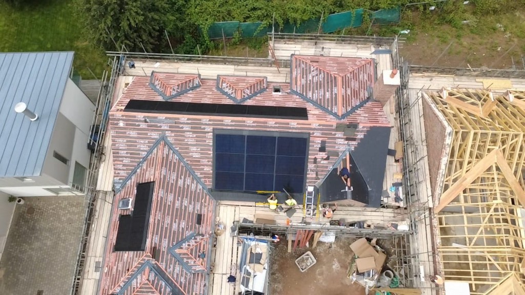 Aerial view of a new build roof with in-roof solar installation underway