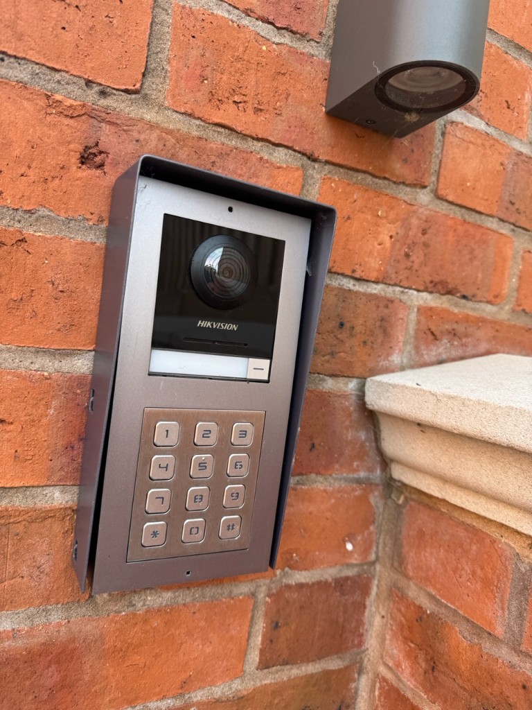Hikvision video intercom and keypad with exterior wall light on brick pillar