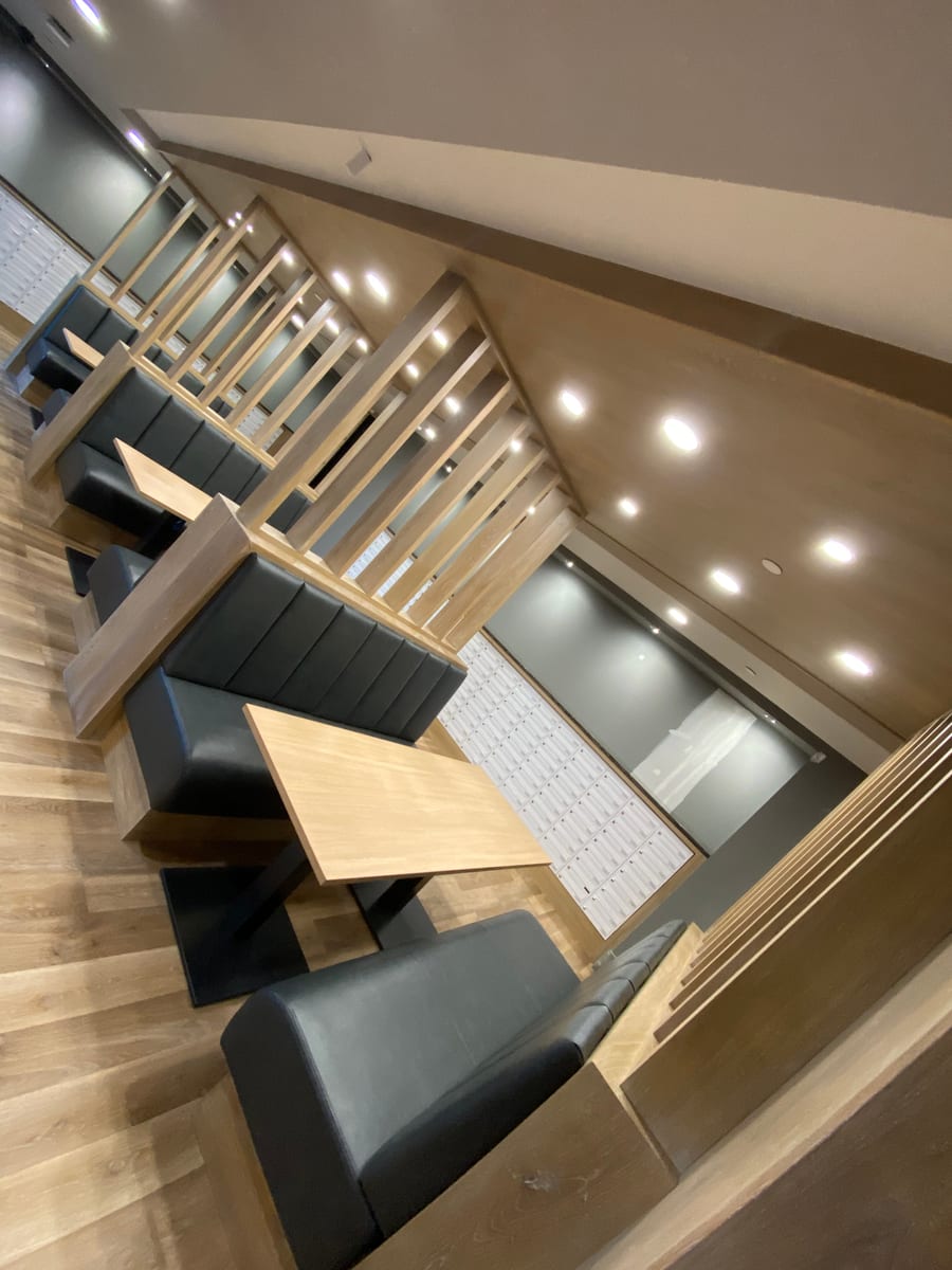Communal study booths with recessed ceiling lighting