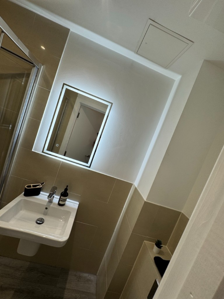Bathroom fit-out showing LED mirror and cove lighting