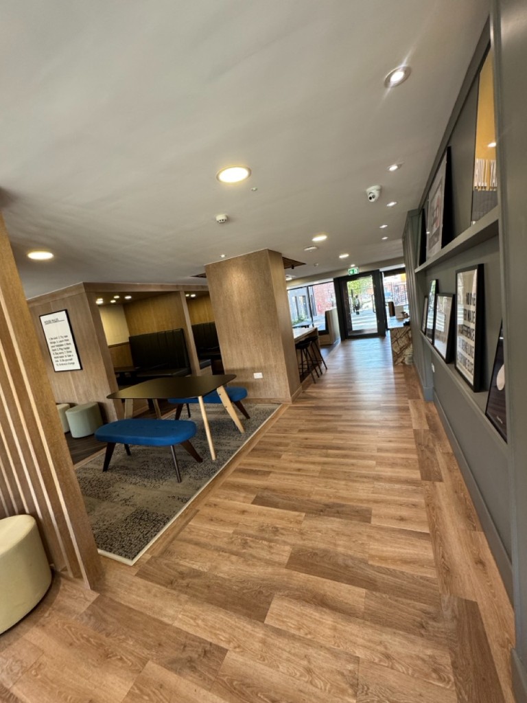 Communal lounge corridor with CCTV and emergency lighting