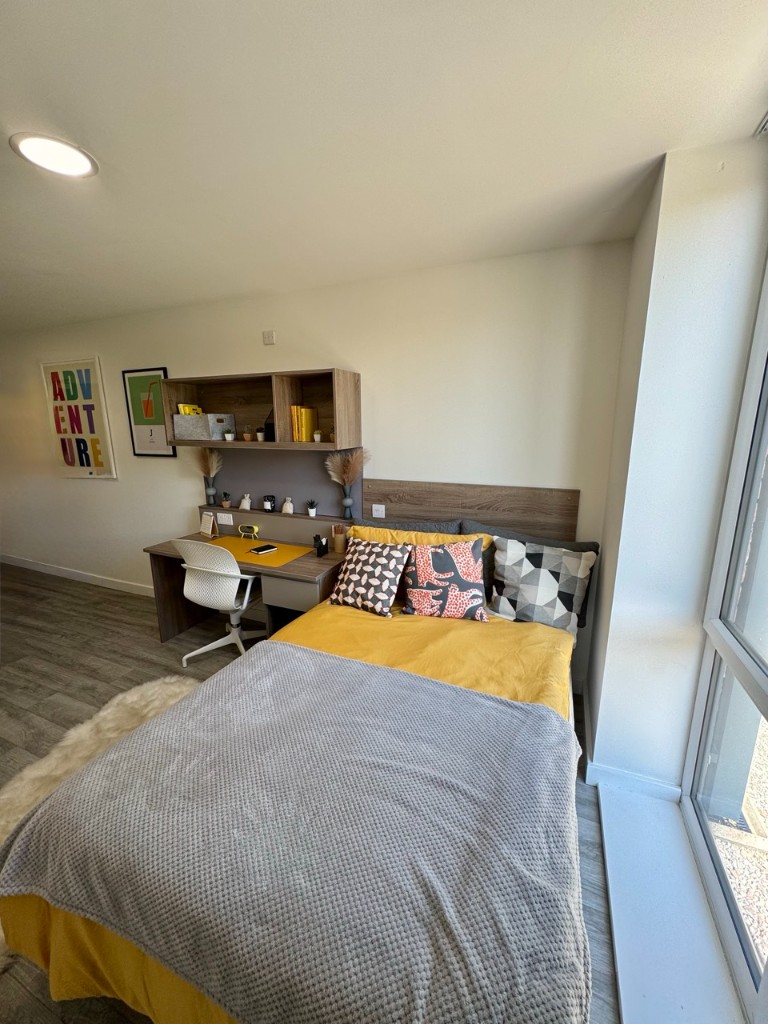 Completed student bedroom with desk and integrated power