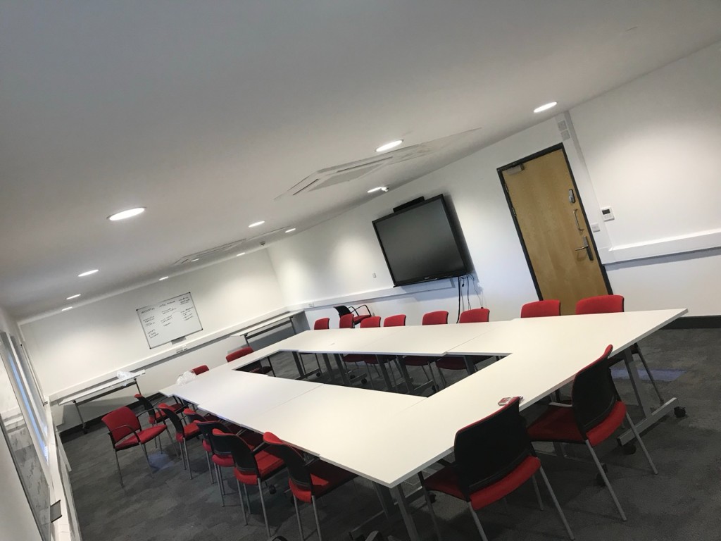 Seminar room with modular tables and recessed lighting