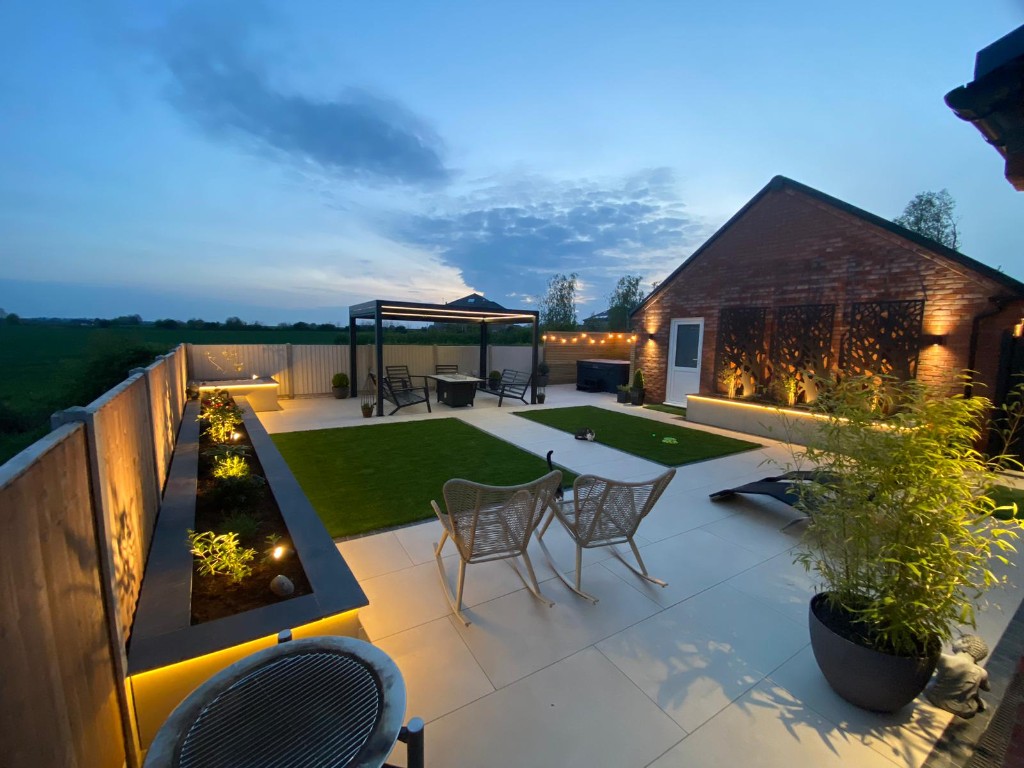 Domestic garden at dusk with integrated LED lighting in Charnwood