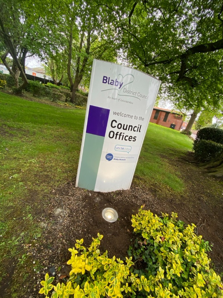 Council offices welcome sign in landscaped grounds