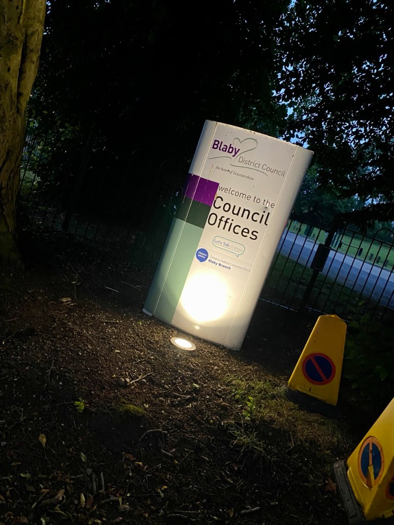 Illuminated Blaby District Council welcome sign at night