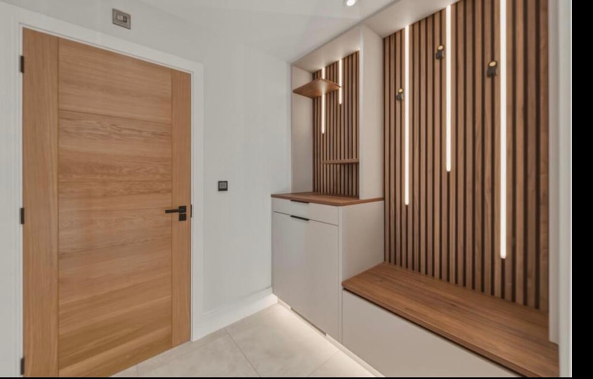Kitchen detail showing island lighting and slat wall feature