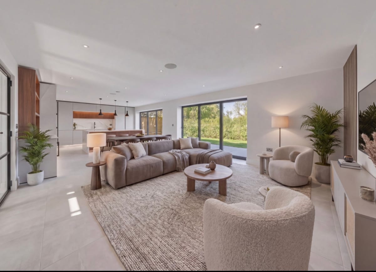 Open-plan kitchen and dining area with marble island and downlights