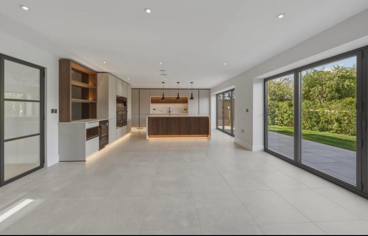 Living space with bi-fold doors and inset fireplace