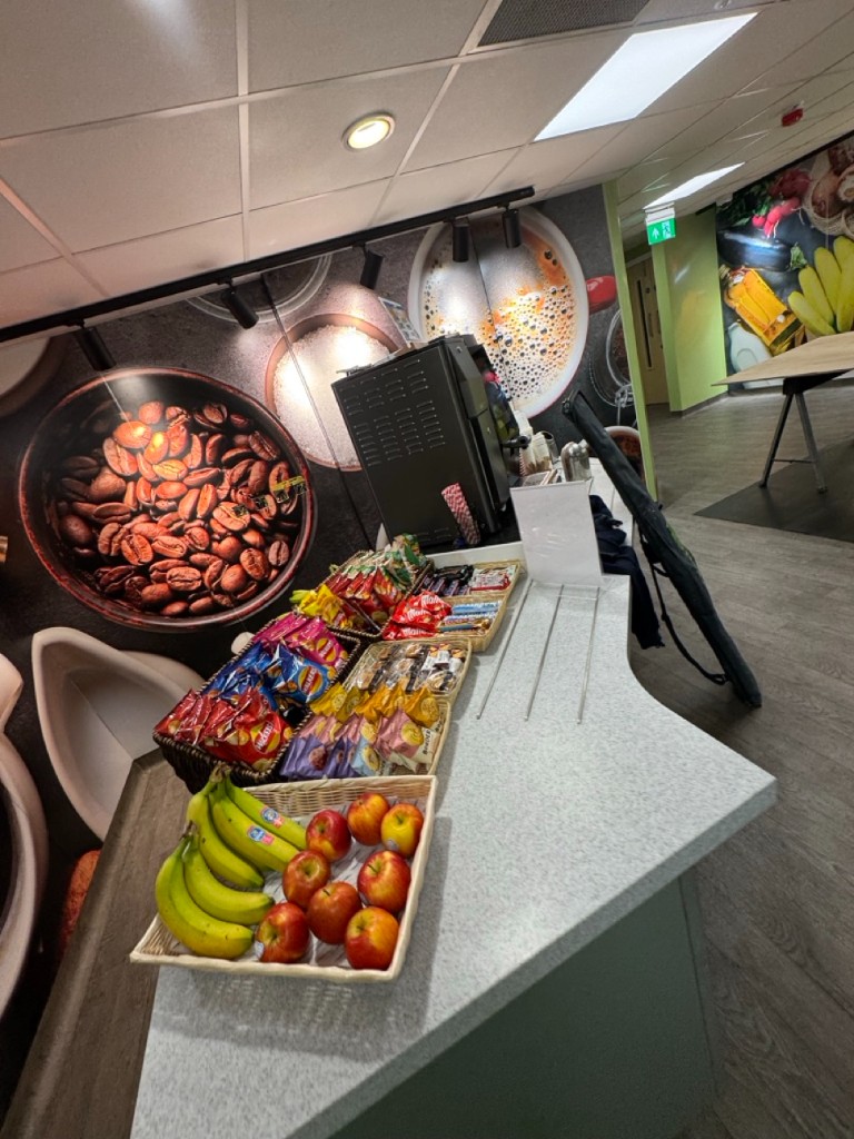 Coffee station with mural, track lights, and appliances