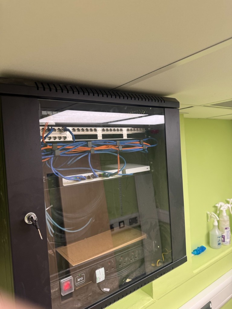 Wall-mounted data cabinet with patch panel and PDU