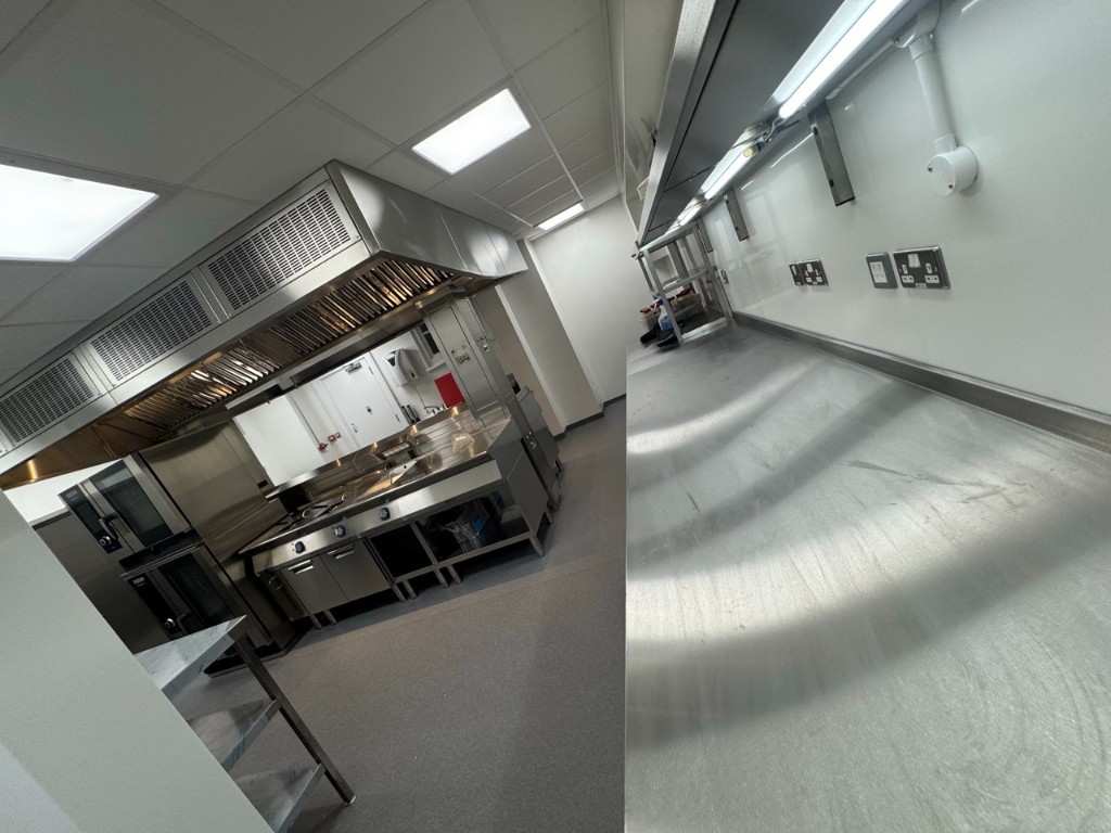 Refurbished NHS commercial kitchen with stainless steel line and LED lighting