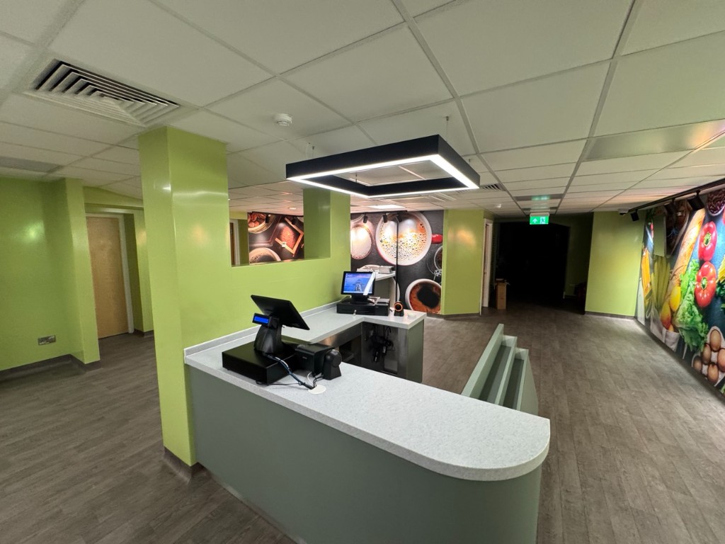 POS checkout counter with feature pendant and wall graphics