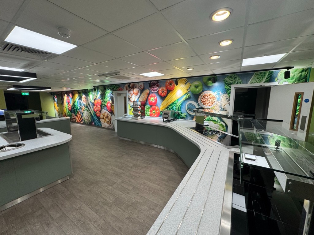 Wide view of refurbished serving area with LED ceiling panels