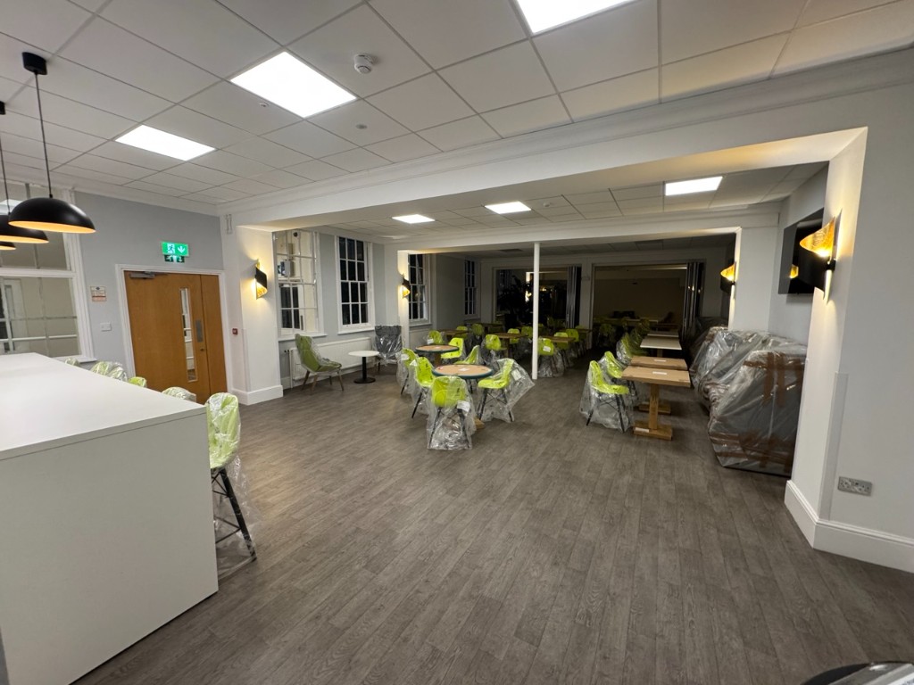 Refurbished dining area with pendant and sconce lighting
