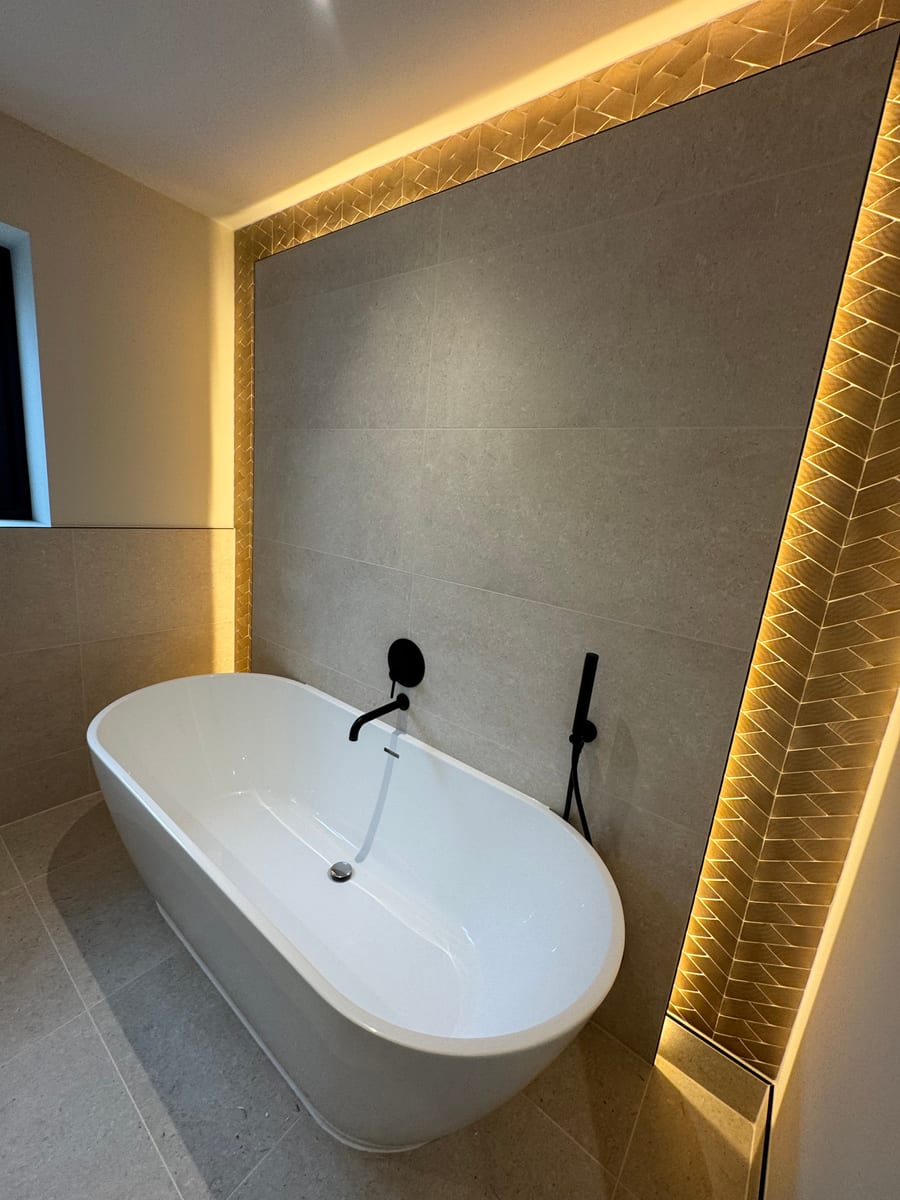 Luxury bathroom with freestanding bath and LED feature wall lighting