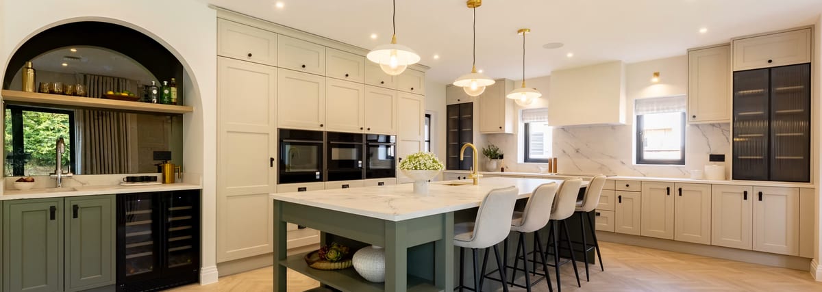 High-spec kitchen with pendant lighting, integrated appliances, and ceiling speakers