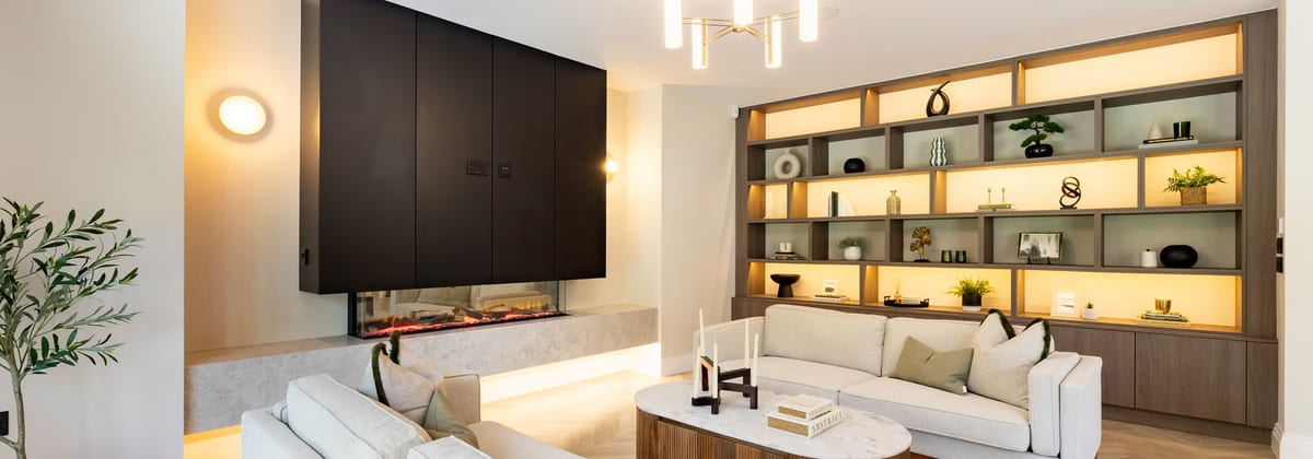 Living room with media wall, cove lighting, and integrated ceiling speakers